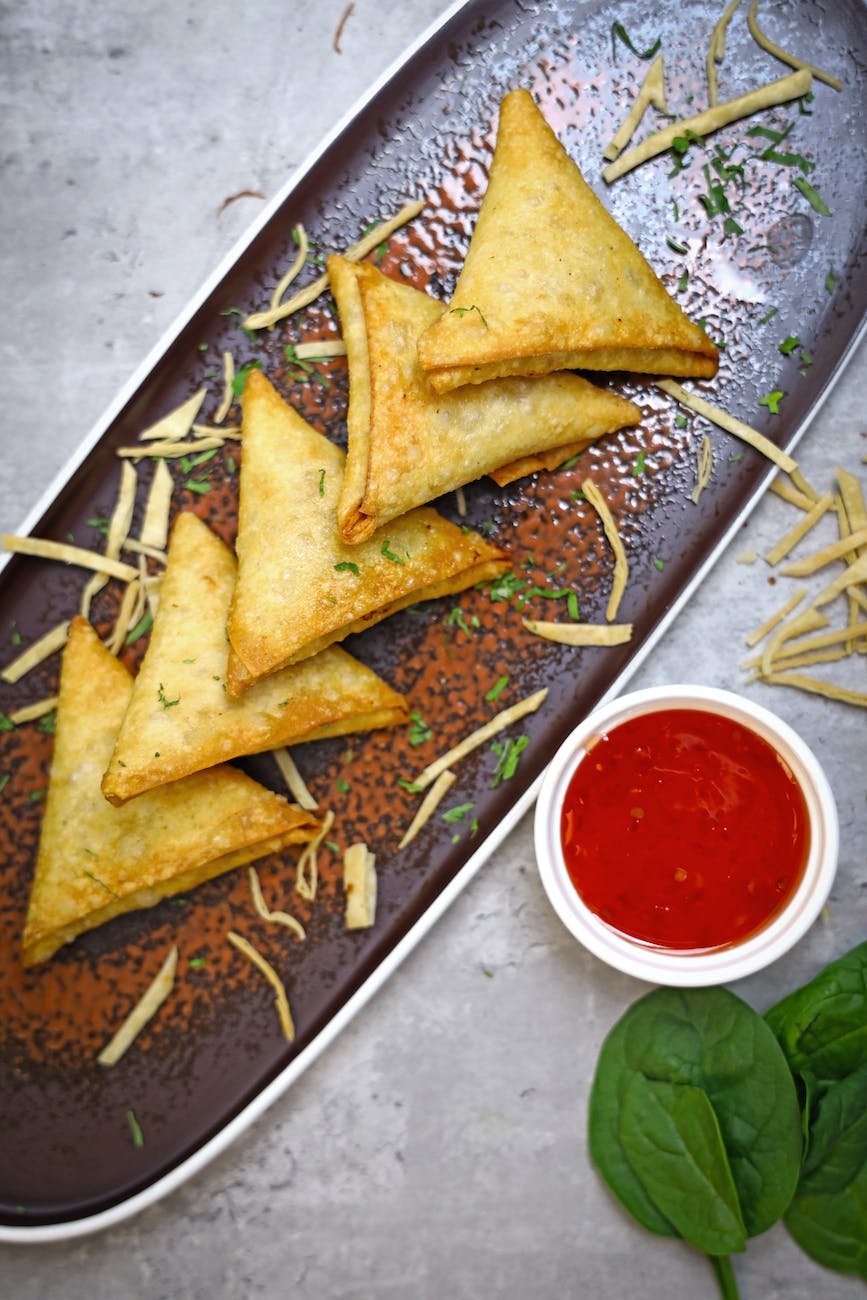 a close up shot of a plate of delicious samosa